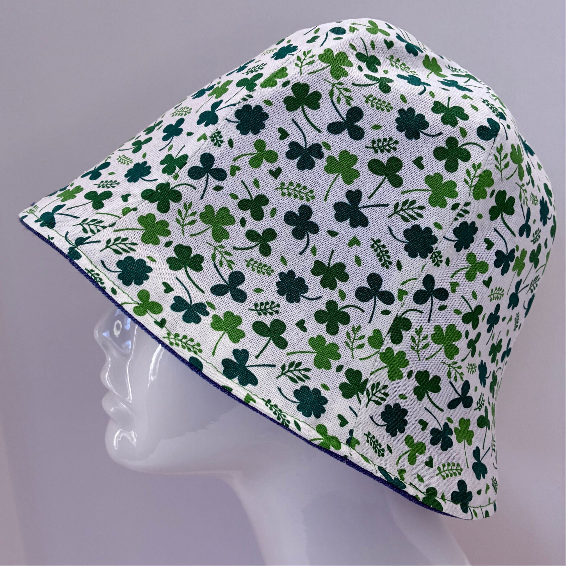 Reversible blue denim hat with green shamrock pattern