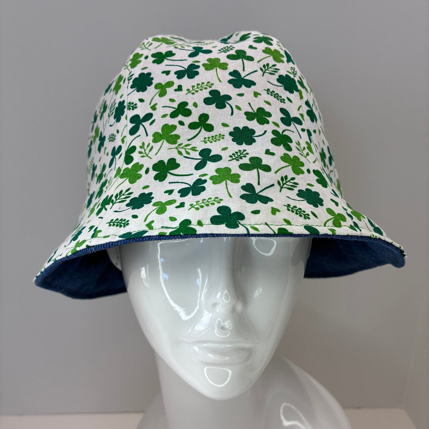 Reversible hat with green shamrock pattern and blue denim